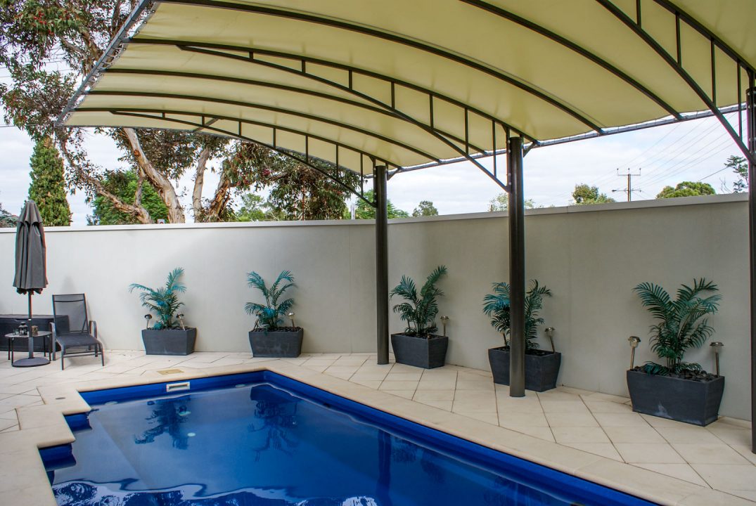 Wide span Vogue pergola shading pool from the sun